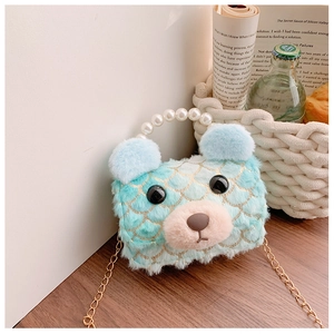 Detailed shot of mint green plush bear bag with pearl handle and golden chain strap