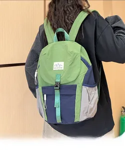 Detail of multi-color block kids hiking backpack with MOUNTAINS logo and durable buckles