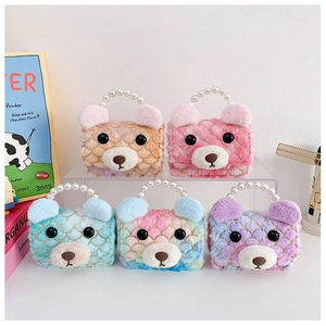 Detail of colorful plush bear handbags with pearl handles and golden scale textures