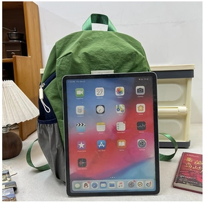 Detail view of large-capacity school backpack with iPad to show scale and interior space