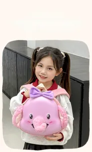 Detail of pink elephant toddler backpack featuring a purple bow and plush texture