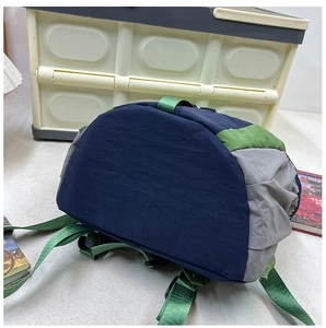 Detail view of durable waterproof nylon fabric and reinforced green carrying handle