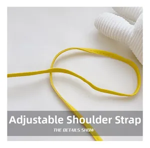 Detail shot of bright yellow adjustable faux leather shoulder strap with neat stitching