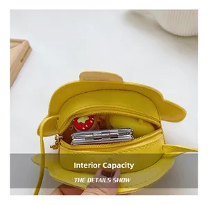 Internal capacity of the yellow cartoon car shoulder bag for kids showing storage space