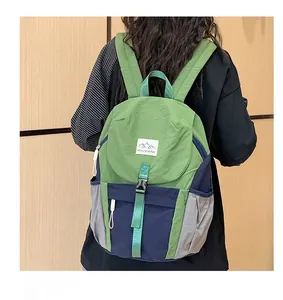 Detail view of water-resistant tricolor nylon backpack with adjustable buckles and mountain logo