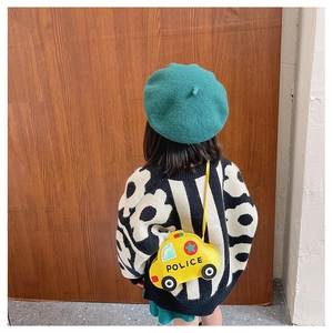 Toddler wearing a yellow police car shaped crossbody bag with black POLICE text on PU leather