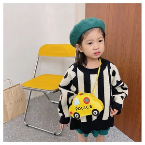 Close-up of a child model wearing a yellow police car shaped crossbody bag in PU leather