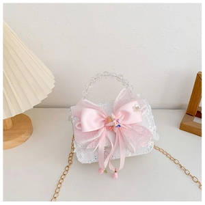Vue détaillée du sac à main pour filles à paillettes avec nœud rose et poignée perlée