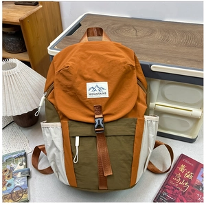 Close-up of color-block backpack with Mountains patch and durable nylon texture