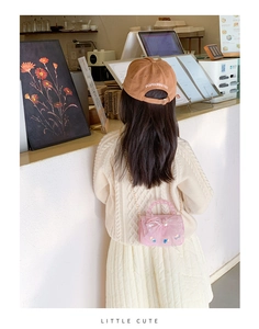 Pink princess bag with lace bow and pearls shown in a cozy cafe setting