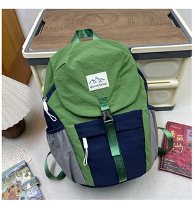 Detail view of the outdoor hiking backpack with MOUNTAINS patch and contrast stitching