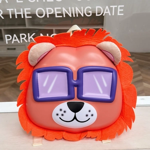 Detail of cute orange lion-shaped hardshell children's backpack with 3D ears and felt mane