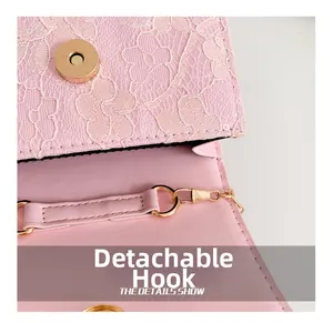 Detail of pink lace handbag featuring detachable golden metal hook and chain strap