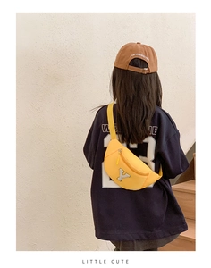 Rear view of a child wearing a bright yellow chest bag with white embroidered 'Y' letter