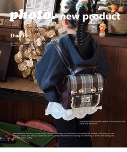 Rear view of child wearing vintage plaid backpack with bowknots and lace trim