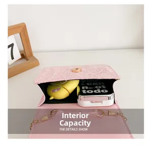 Internal capacity of pink lace bag showing space for cosmetics and earphones