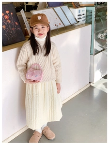 Close-up of pink lace mini handbag with pearl handle on a stylish child outfit