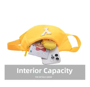 Internal capacity of yellow kids waist bag showing phone, notepad and earbuds