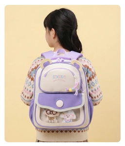 Detail of purple toddler backpack featuring a clear window with plush toys and 3D ears