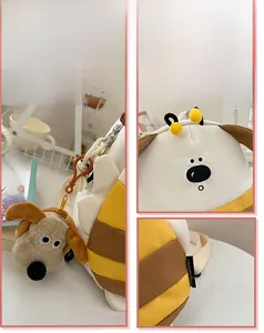 Detail view of cartoon stripe backpack with plush dog charm and side brand label