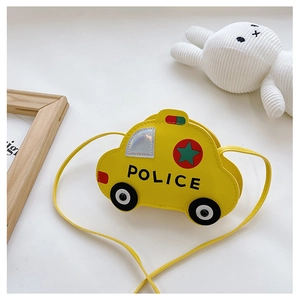 Detail of yellow police car shaped crossbody bag for kids on a clean white desk setup