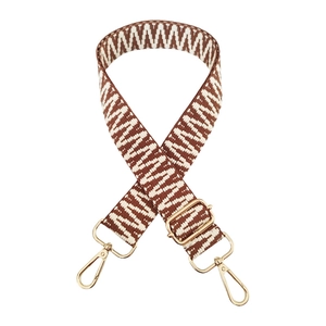 Detail of woven brown and white strap with geometric patterns and golden metal lobster clasps