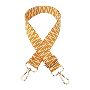 Detail of orange and white wave pattern woven strap with gold metal lobster clasps