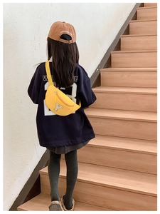 Detail of bright yellow canvas kids waist bag with gray letter Y patch embroidery