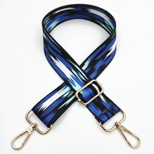 Adjustable geometric pattern bag strap with gold metal hooks and blue-white weave texture