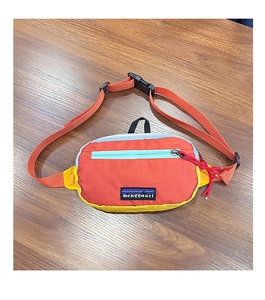 Detail of kids multi-color ripstop nylon hip pack with mountain logo and adjustable strap