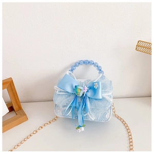 Detail of light blue lace kids handbag with bow, bead handle and gold chain strap