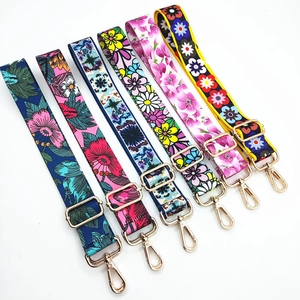 Adjustable wide ethnic style handbag straps with colorful floral prints and gold metal hooks