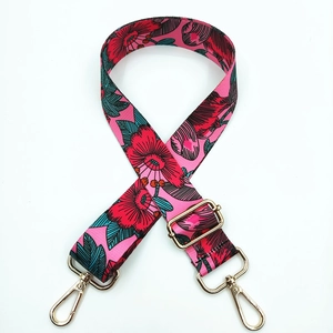 Detail of adjustable floral strap with pink background and gold metal lobster clasps