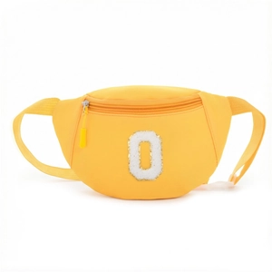 Detailed macro view of yellow nylon fanny pack with plush letter O and secure zipper closure