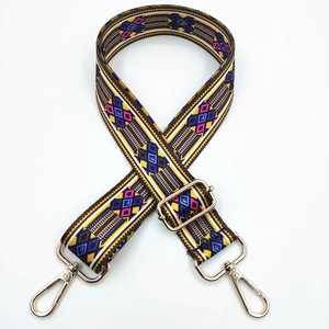 Close-up of ethnic geometric pattern woven strap with gold metal hooks and adjusters