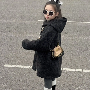 Toddler girl in black fuzzy hooded coat holding a chic mini contrast chain bag outdoors