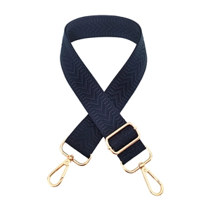 Adjustable navy blue crossbody strap with chevron pattern and gold metal hardware