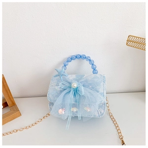 Detail of light blue girls' bag featuring lace texture, mesh bow, and starfish pendant