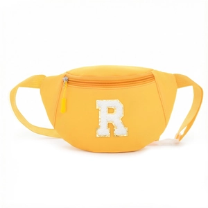 Detailed view of yellow waist bag showing durable fabric and white plush R-letter patch