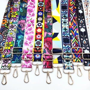 Detail view of colorful patterned shoulder straps with gold-tone hardware and buckles