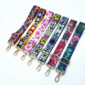 Adjustable woven shoulder straps with colorful floral and bohemian patterns and gold buckles