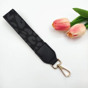 Detail of grey leopard print fabric wrist strap with gold metal lobster clasp