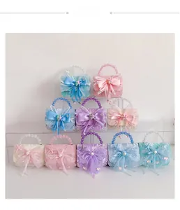 Close-up of kids lace handbags with pearl handles and bow details in pastel colors