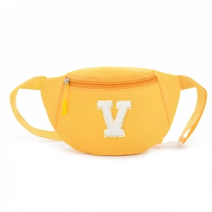 Detail of a bright yellow kids waist bag featuring a large white sequined V patch embroidery