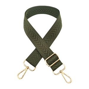 Detail of dark green 3.8cm wide bag strap with arrow pattern and gold metal hooks