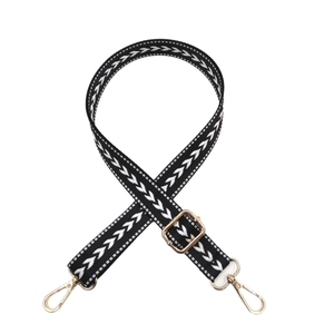 Adjustable black and white arrow patterned nylon bag strap with gold metal buckles