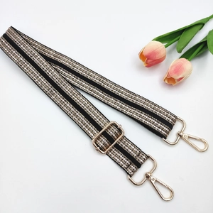 Black canvas strap with five rows of sparkling rhinestones and golden metal hardware