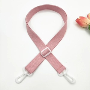 Close-up of light pink cotton strap featuring white plastic buckle and rotating swivel hook