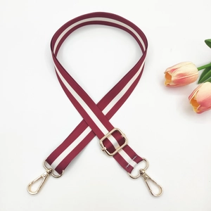 Close-up of adjustable wine red striped bag strap with premium gold metal hardware hooks