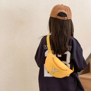 Kids trendy yellow waist bag with silver sequin letter Y on blue sweatshirt backdrop